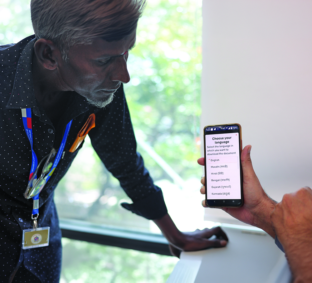 A customer using a mobile phone for a digital transaction.