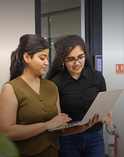 Two Bajaj Finserv colleagues collaborating over a laptop