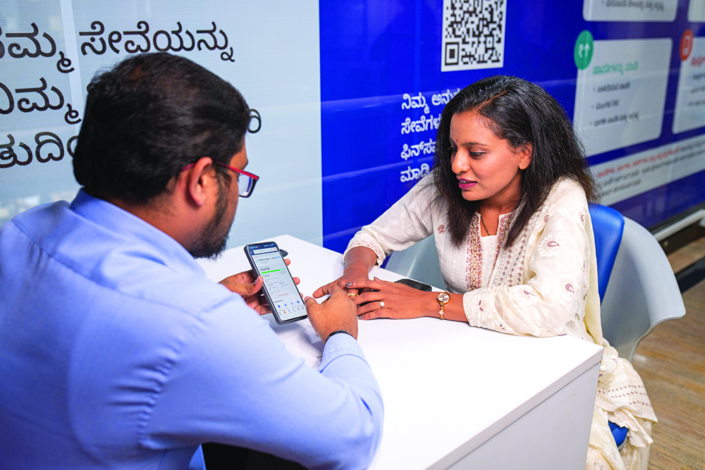 A Bajaj Finserv representative helping a customer at a branch.