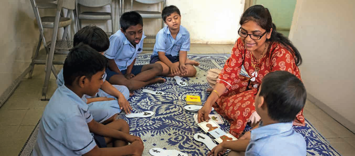 An educator working with children with disabilities during an inclusive learning session.